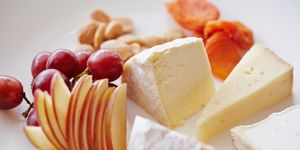 Close up of plate of fruit, cheese and nuts
