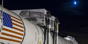 In this handout provided by NASA, the moon rises ahead of the second and final qualification motor (QM-2) test for the Space Launch System's booster on Tuesday, June 28, 2016, at Orbital ATK Propulsion Systems test facilities in Promontory, Utah. 