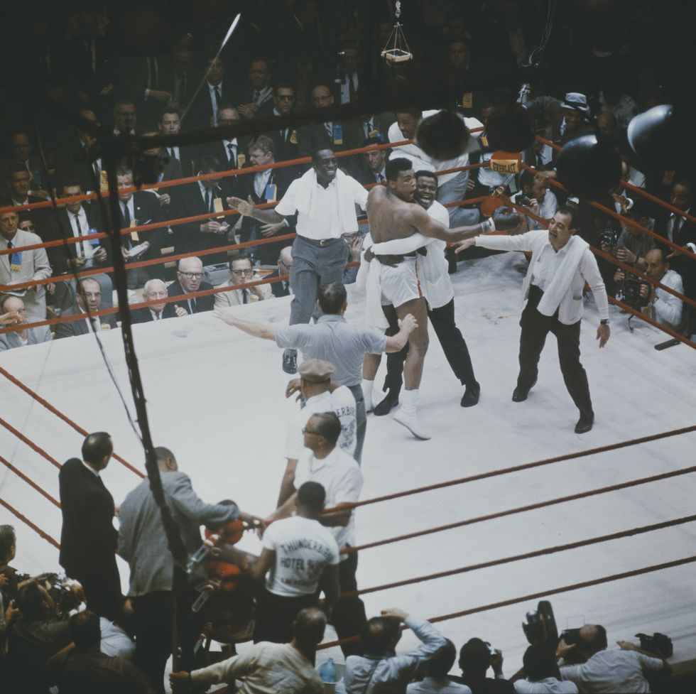 Muhammad Ali is congratulated by his cornerman, Drew Bundini Brown and trainer Angelo Dundee (right) after beating Sonny Liston to become the Heavyweight Champion of the World in Miami Beach, Florida on February 25, 1964