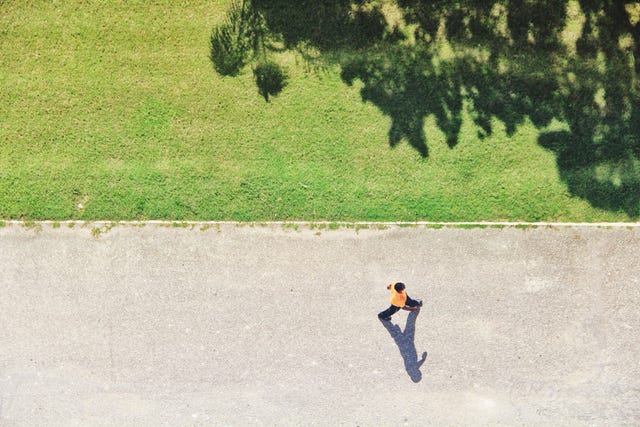 man walking on park alley