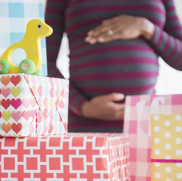 woman admiring gifts at baby shower