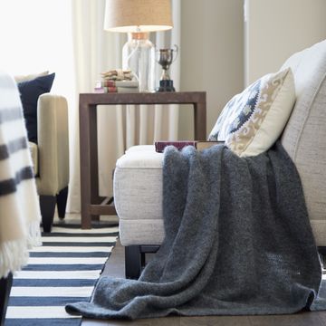 Gray blanket over chair in elegant living room