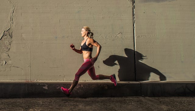 Female runner running on sidewalk