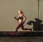 Female runner running on sidewalk