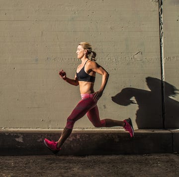 Female runner running on sidewalk