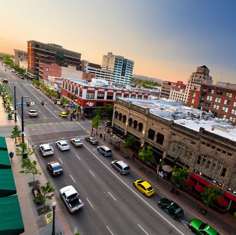 aerial view of traffic on idaho and 8th street with capitol rotunda visible in distance in downtown boise, idaho, at sunset