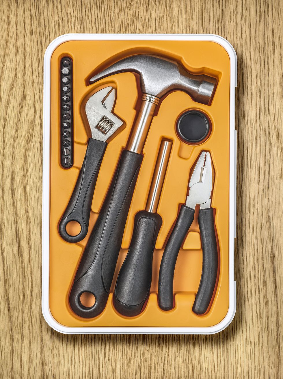 a tool box that contains a hammer, screwdriver, pliers, wrench all contained in a modern plastic container