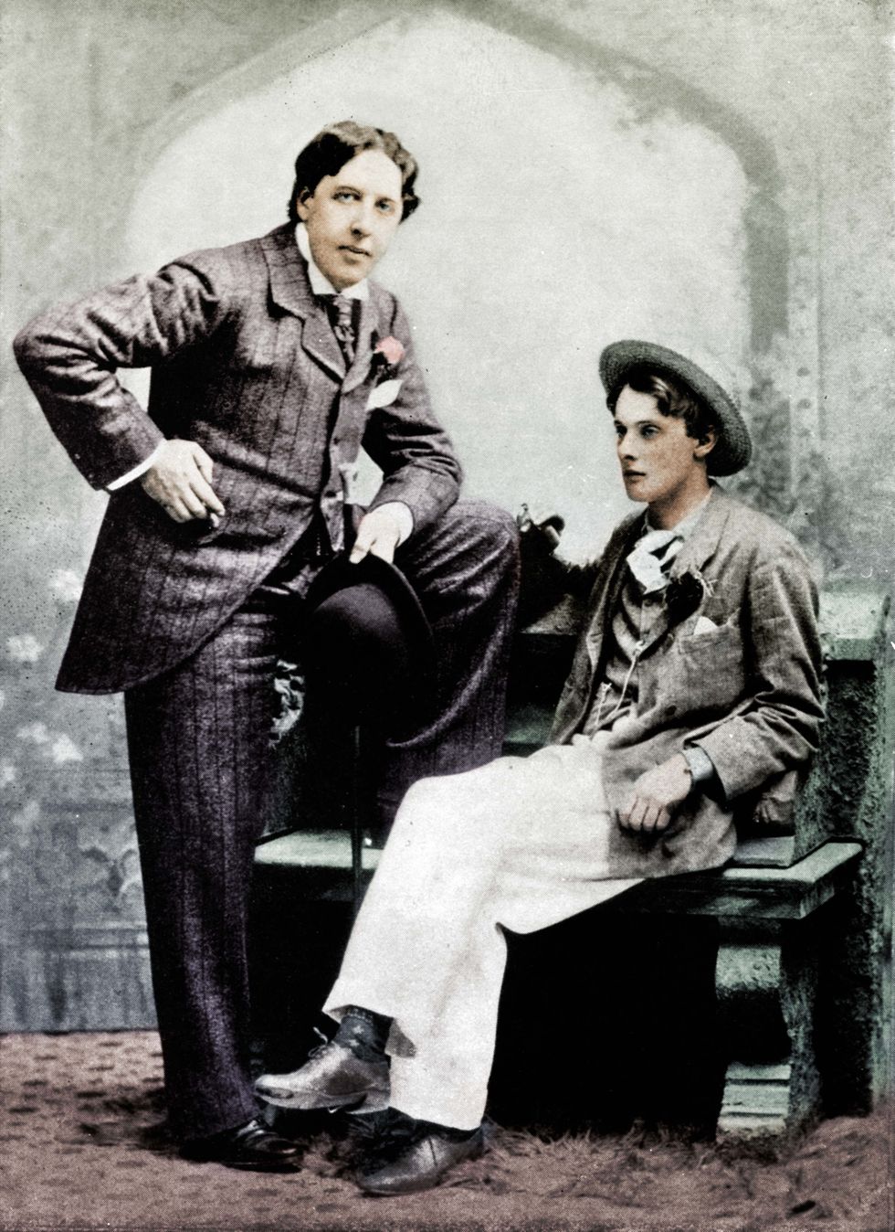 Writer Oscar Wilde standing next to his seated lover 'Bosie' Douglas