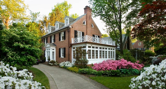 american traditional center hall colonial revival brick home with dormers