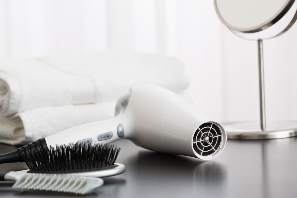 Hair dryer and towels on table