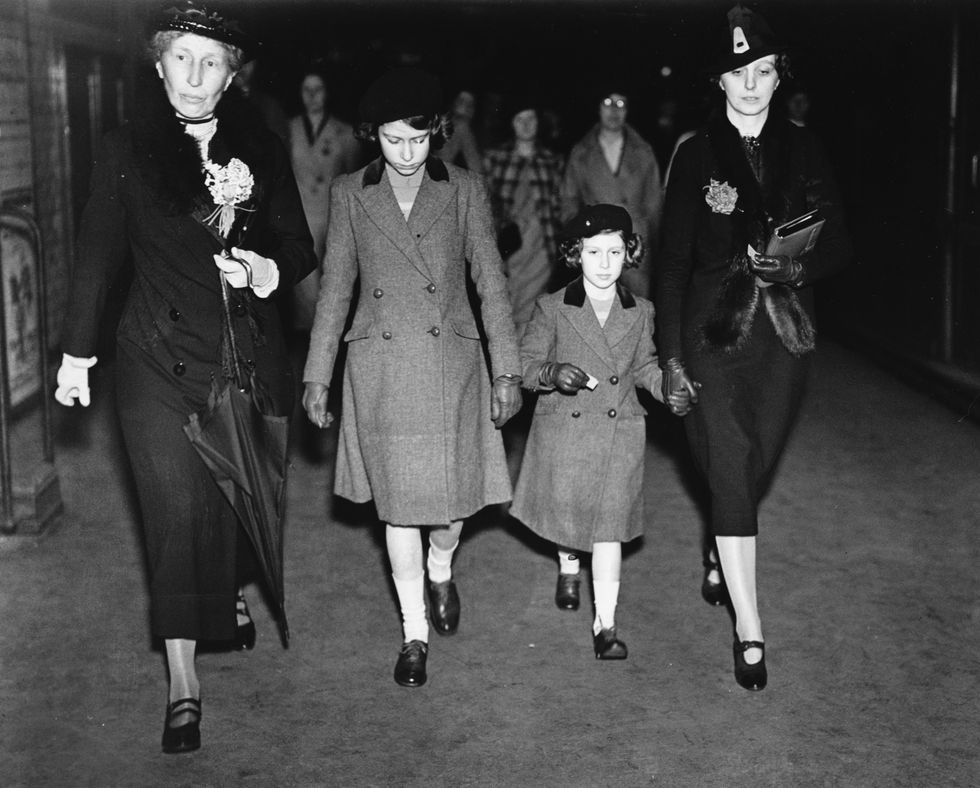 british princesses elizabeth second left and margaret are accompanied by lady helen graham left and governess marion kirk crawford right as they arrive for their first ride on an london underground tube train at st jamess park, london, may 15th 1939 photo by central presshulton archivegetty images