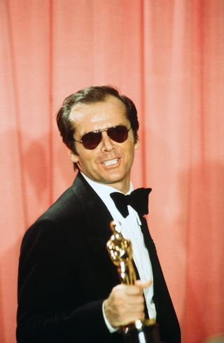 Jack Nicholson poses with his first Oscar for One Flew Over the Cuckoo's Nest in 1976.﻿