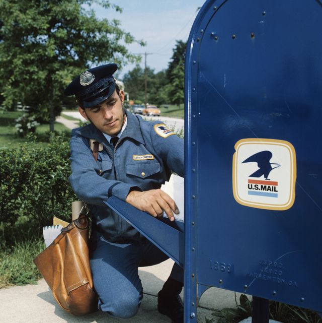 1970s mailman taking mail out of mail drop box  photo by h armstrong robertsclassicstockgetty images