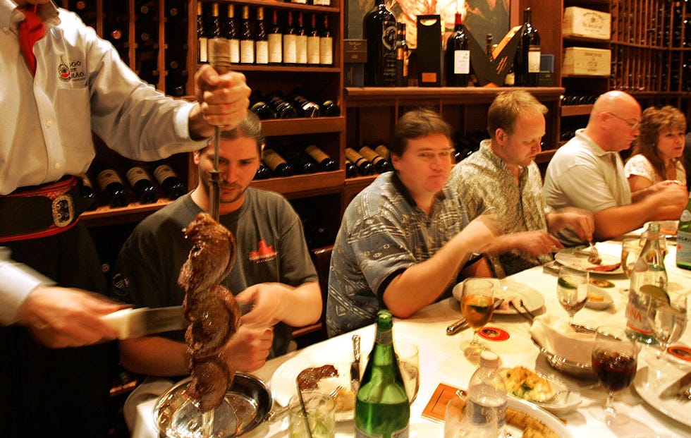 a gaucho chef slices the picanha, the signature sirloin, for a private party at fogo de chao