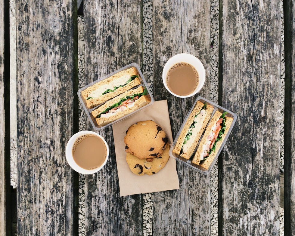 Coffee, sandwiches and cookies on the old table