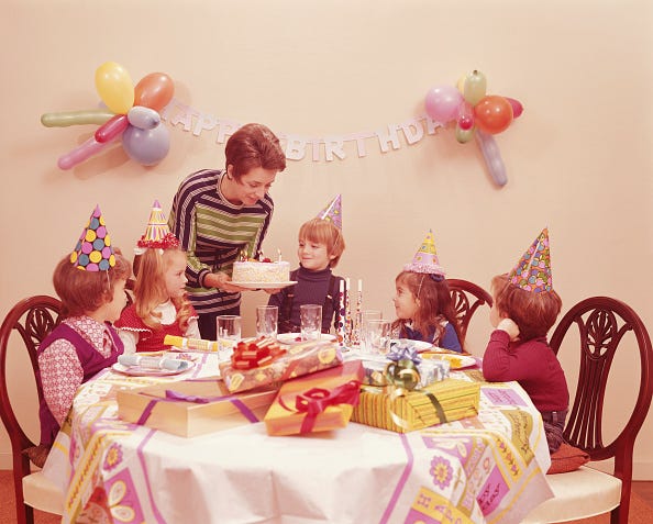 united states circa 1970s: five children at birthday party, mother serving birthday cake. (photo by h. armstrong roberts/retrofile/getty images)