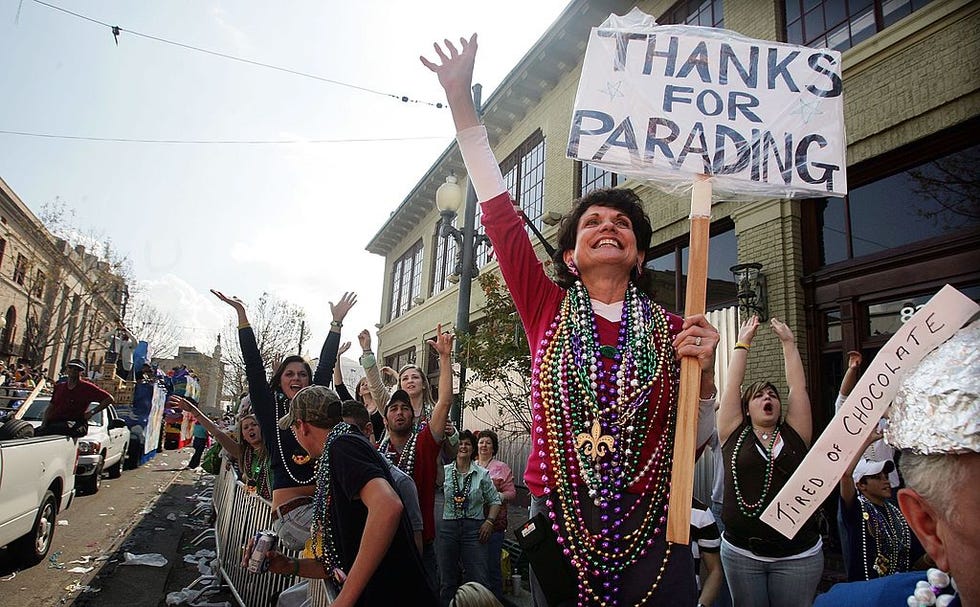 carol cowley waves while watching the tucks parade during mardi gras festivities