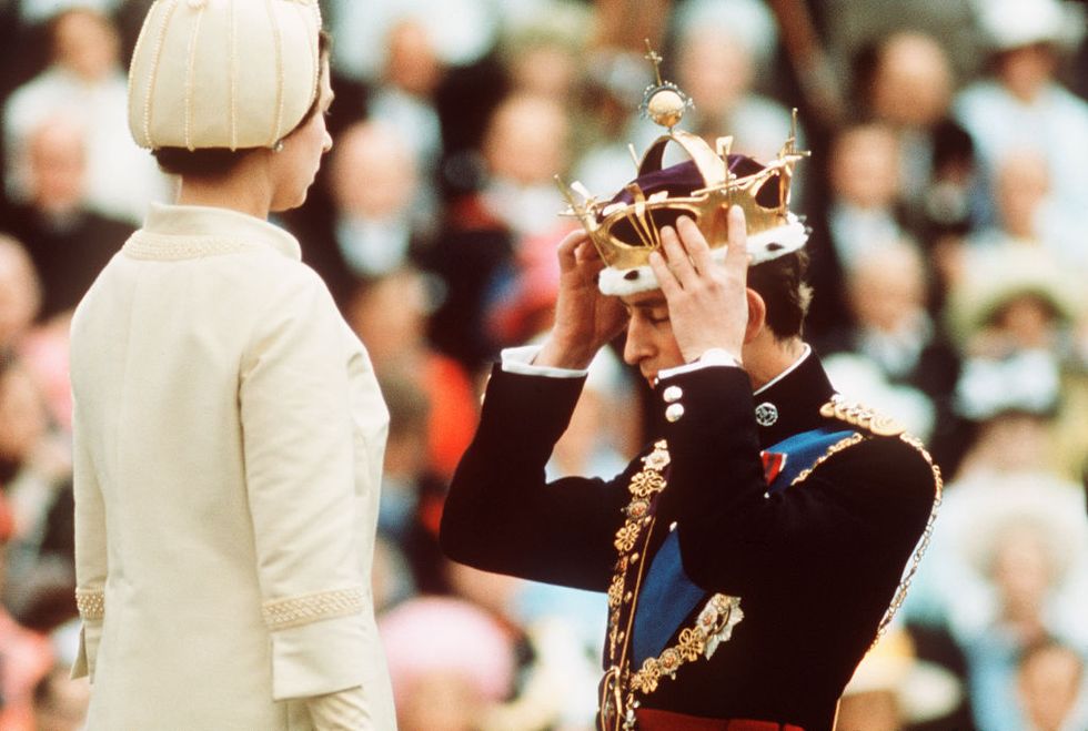 caernarvon   july 1  prince charles kneels before queen elizabeth as she crowns him prince of wales at the investiture at caernarvon castle on july 1, 1969 in wales photo by anwar husseingetty images