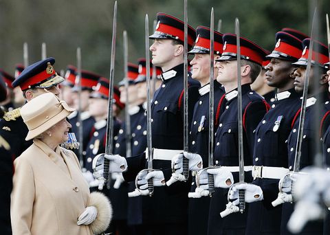 surrey, england   april 12  queen elizabeth ii as proud grandmother smiles at prince harry as she inspects soldiers at their passing out sovereigns parade at sandhurst military academy on april 12, 2006 in surrey, england photo by tim graham photo library via getty images