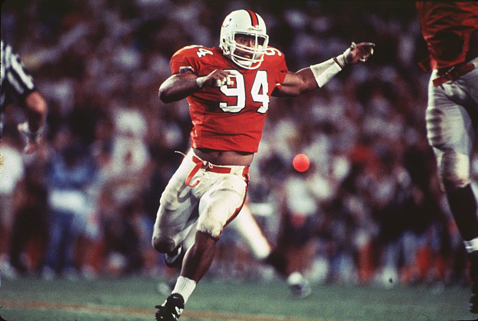 Dwayne Johnson of the University of Miami Hurricanes runs upfield to make the stop at the Orange Bowl in Miami, Florida, 1992