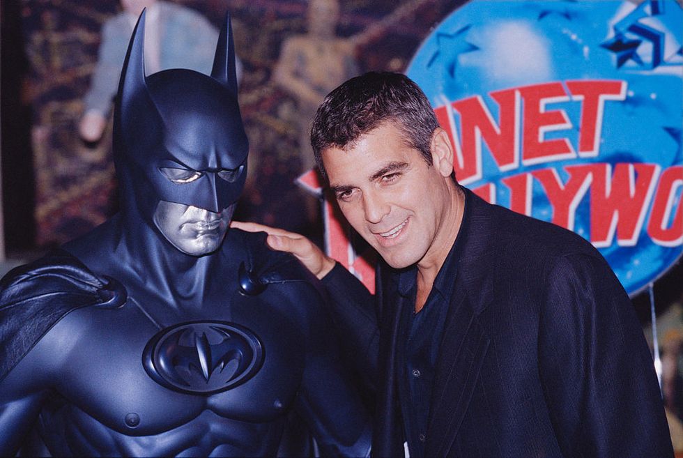 american actor george clooney poses with a model of batman during a photocall for his latest film batman and robin at planet hollywood, london, uk, 23rd june 1997 photo by colin daveygetty images
