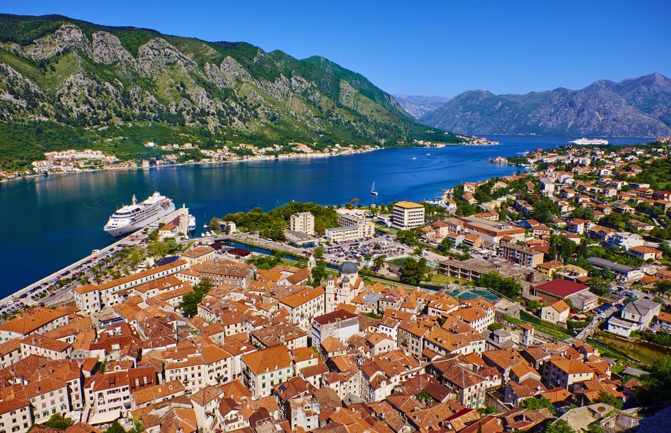 montenegro, adriatic coast, bay of kotor, kotor, elevated view over the old town, fjord and mountains from the walls of the kotor fortress which forms a continuous belt around the old town