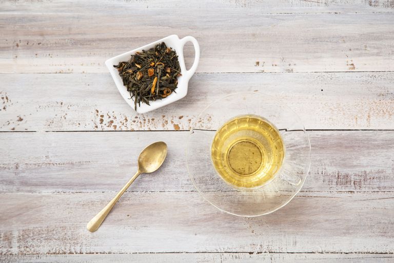 Loose leaf green tea blend, glass teacup and spoon
