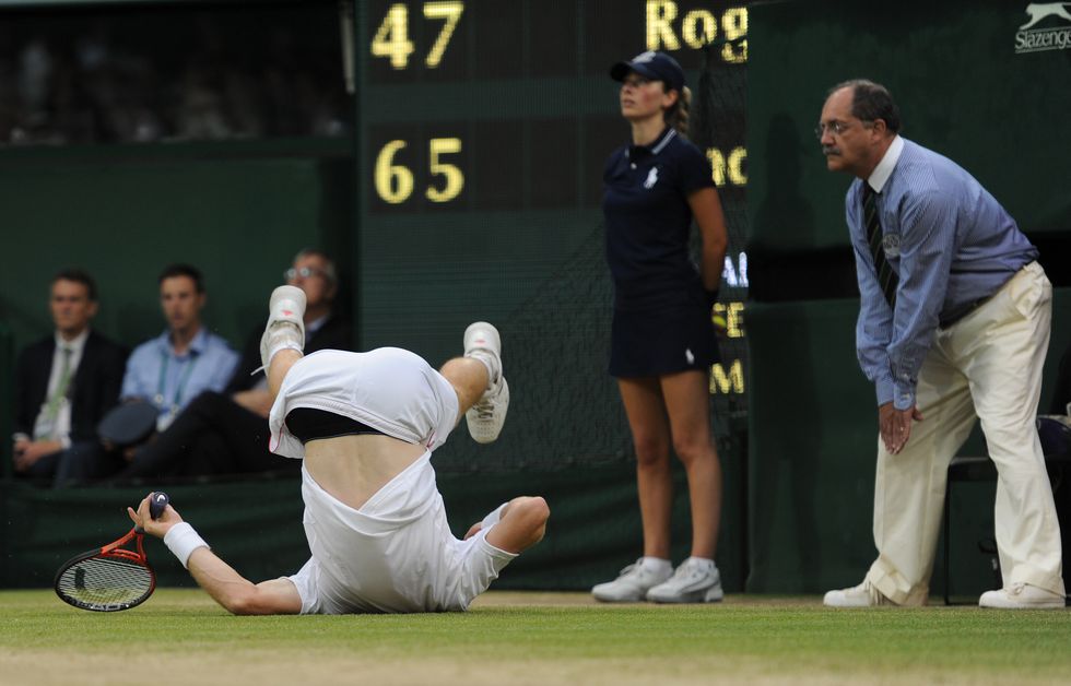 andy murray slips on to the grass during his mens singles final match against roger federer on day thirteen of the 2012 wimbledon tennis championships at the all england lawn tennis and croquet club in london, united kingdom photo visionhausben radford photo by ben radfordcorbis via getty images
