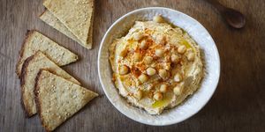 Bowl of Hummus and flat bread on wood