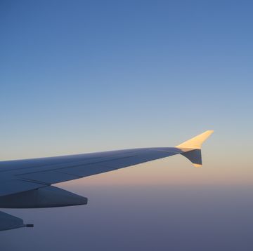 Plane wing and clear sky during flight