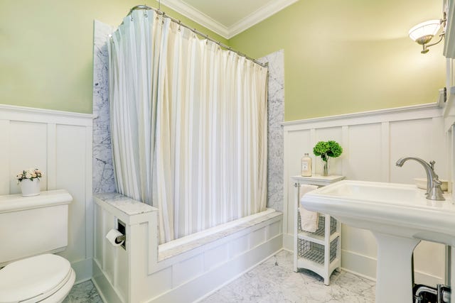 lovely marble bathroom with full bath shower, washbasin stand and toilet. northwest, usa