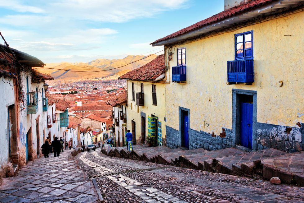 Historic architecture of Cusco along steep street northwest of Plaza de Armas, Peru