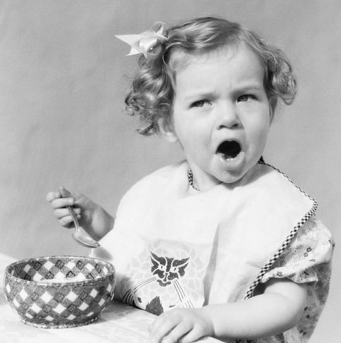 1930s girl eating in highchair making funny face mouth open photo by h armstrong robertsclassicstockgetty images