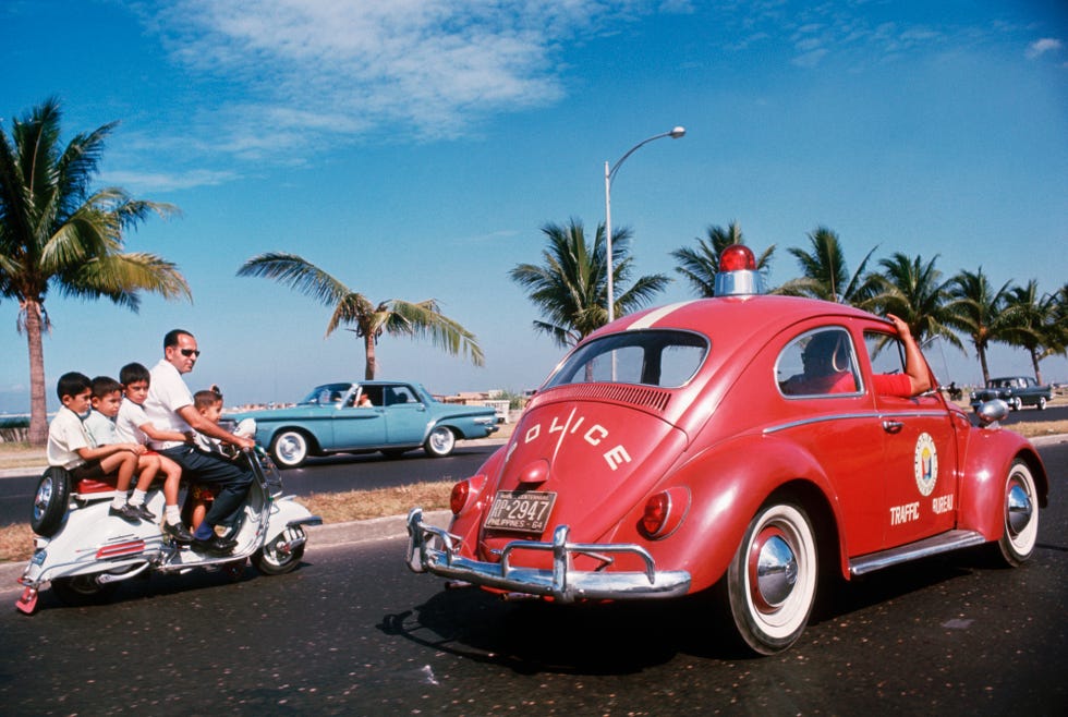 Police Car and Family on Scooter