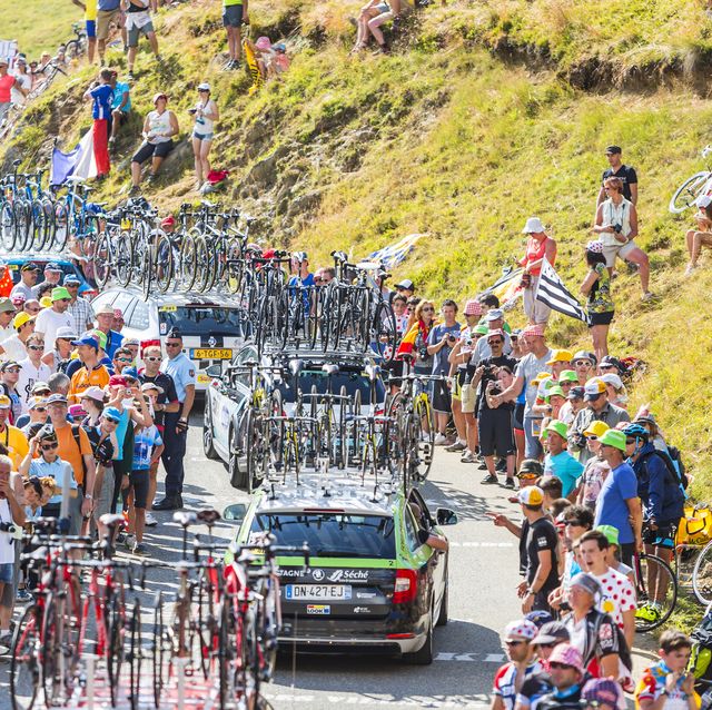 col du glandon, france july 23, 2015 row of technical cars driving on the road to col du glandon in alps during the stage 18 of le tour de france 2015