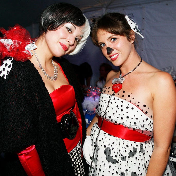 cruella deville and dalmation attend central park conservancys halloween ball