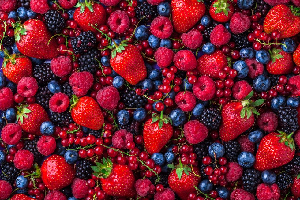 forest fruit berries overhead assorted mix in studio on dark background with raspberries, blackberries, blueberries, red currant
