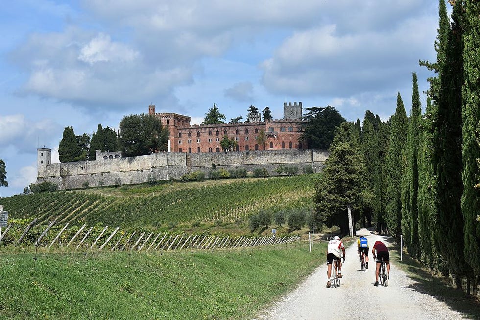 a group of cyclists rides past the castle of brolio, on the eve of leroica, a retro cycling event, on october 1, 2016 in gaiole in chianti near siena riders from all over the world, wearing vintage cycling jerseys, took part in leroica through the strade bianche, the gravel roads of the chianti area of tuscany, today on october 2, 2016   afp  giuseppe cacace        photo credit should read giuseppe cacaceafp via getty images