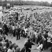 A crowd gathers outside the gates of Graceland, for the funeral of Elvis Presley.