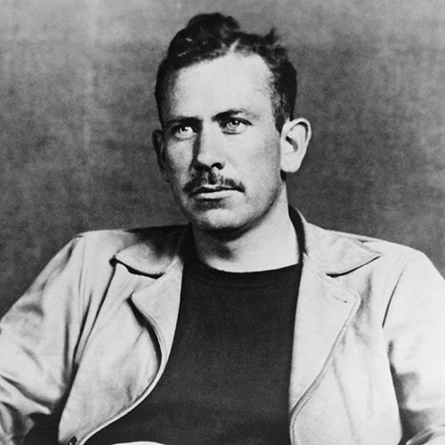 john steinbeck looks past the camera with a neutral expression on his face, he is wearing a light jacket and a dark shirt