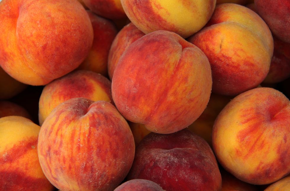 peaches were first cultivated in china its believed that cultivation started circa 2000 bc although peaches are grown widely in north america and europe, china remains the largest producer of peaches in the world this was photographed in a farmers market in ontario, canada