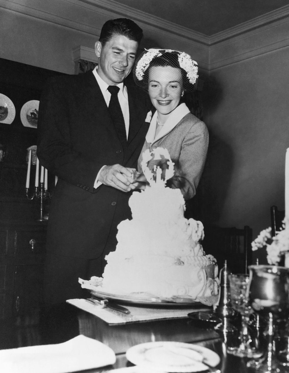 Ronald and Nancy Reagan cutting the cake at their wedding on March 4, 1952