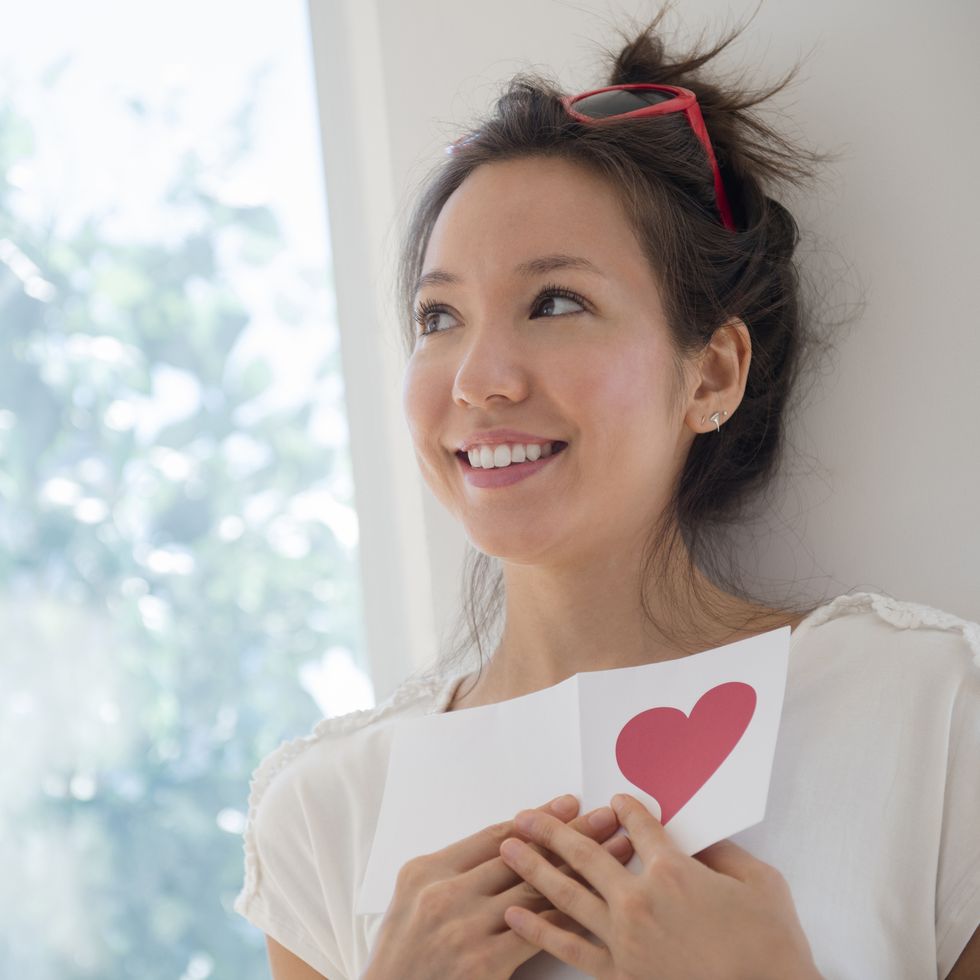 a woman holding a valentine card