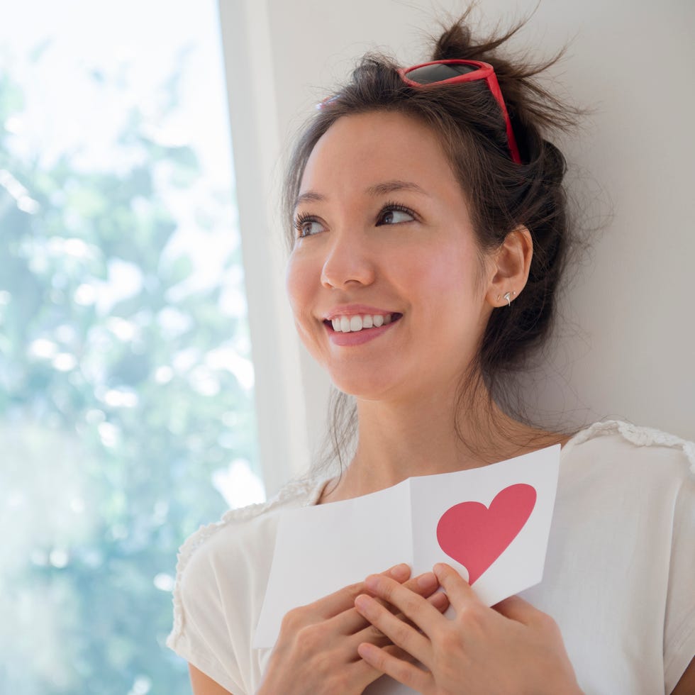 a woman holding a valentine card