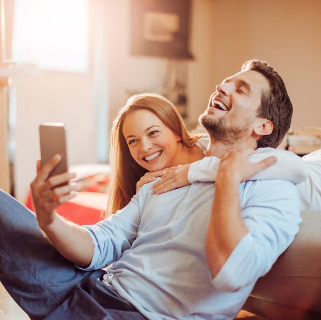 close up of a happy young couple using a phone
