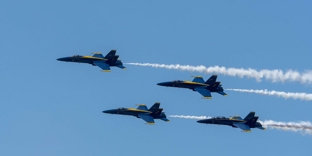 Blue Angels F/A-18 Hornets are flying The Diamond Roll (four