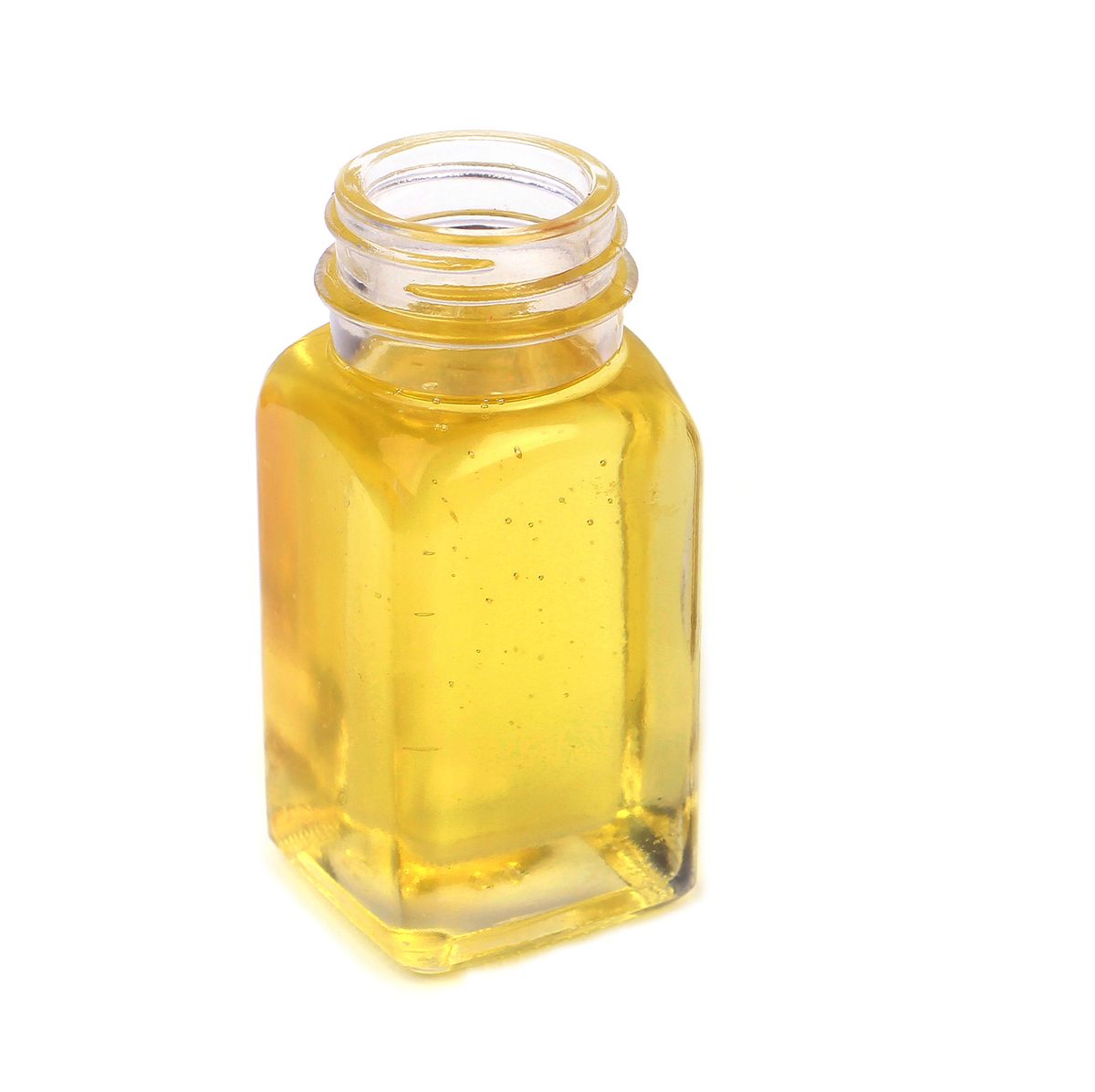 castor oil in glass bottle on white background