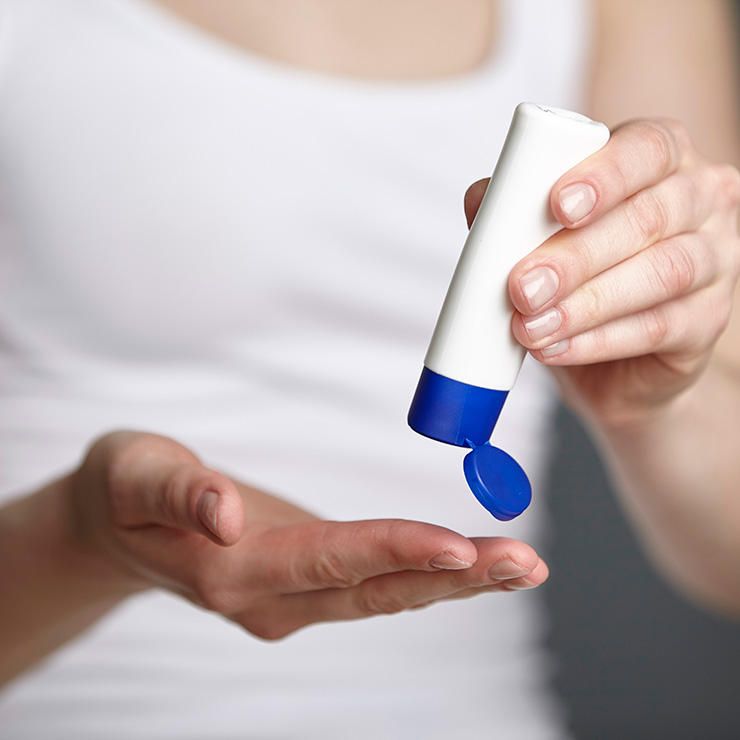 woman putting cream on her hands