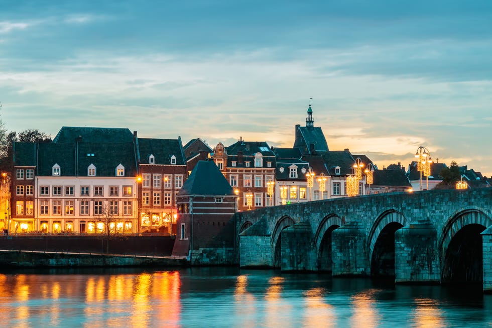 view at the famous dutch sint servaas bridge with christmas lights in the city center of maastricht