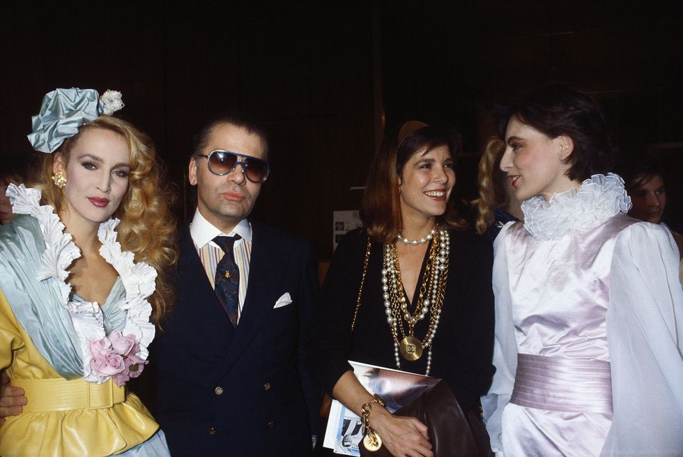 l r model jerry hall in an outfit by chanel, designer karl lagerfeld, princess caroline of monaco, and model ines de la fressange attend the chanel 1985 spring summer haute couture fashion show in paris photo by pierre vautheysygmasygma via getty images
